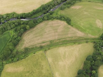 Oblique aerial view of the grassmarks of the Roman Fortlet at Kirkland, taken from the SSW.