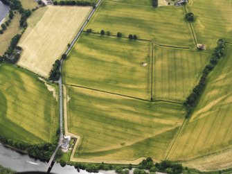 Oblique aerial view of the cropmarks of the Roman Temporary Camps at Mertoun Bridge, taken from the ENE.