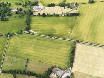 Oblique aerial view of the cropmarks of the Roman Temporary Camps at Mertoun Bridge, taken from the SE.
