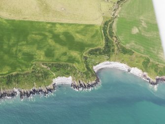 Oblique aerial view of The Dunnan promontary fort and Portankill, taken from the ENE.