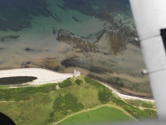Oblique aerial view centred on the ruins of Greenan Castle, taken from the SSE.
