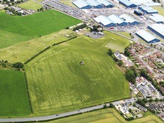 Oblique aerial view of the cropmarks of the fort, and the windmill and dovecot, taken from the NW.
