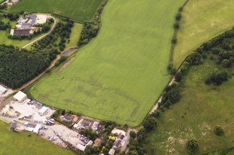 Oblique aerial view of the cropmarks of the possible enclosure, looking to the WSW.