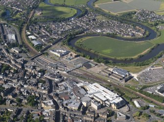 General oblique aerial view of Stirling centred on the railway station, taken from the SSW.