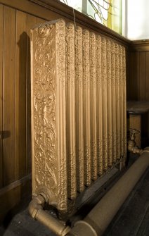 Interior. Main hall.  Detail of decorative radiator.
