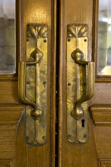 Interior. Ground floor.  Entrance lobby.  Detail of door handles with acorn fingure plates.
