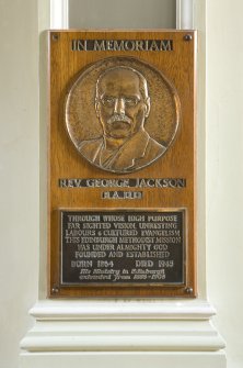 Interior. First floor.  Landing.  Detail of memorial plaque to Rev. George Jackson.