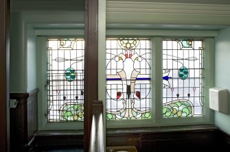 Interior. First floor. Gent's lavatory.  Stained glass.