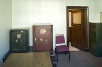 Interior. Second floor.  Steward's room with safes and door to lavatory.