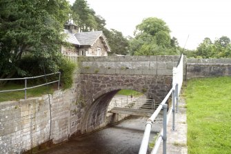 General view of bridge over the sluice leading from the leading the dam, from NW.