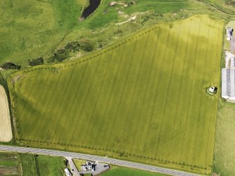 Oblique aerial view of the remains of the windmill and Glenglassaugh Distillery at Sandend, looking to the N.