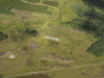 Oblique aerial view of the Camster chambered cairns and the adjacent sheepfold, taken from the SE.
