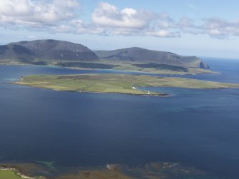 General oblique aerial view looking across Graemsay towards Hoy, taken from the NE.