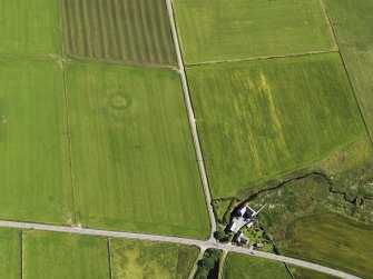 Oblique aerial view of the Hall of Ireland with a vegetation mark showing the ditch and the Mill of Ireland adjacent, taken from the SSW.