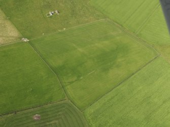 Oblique aerial view of the cropmark of the field boundary with Northbreck farmstead adjacent, taken from the ESE.