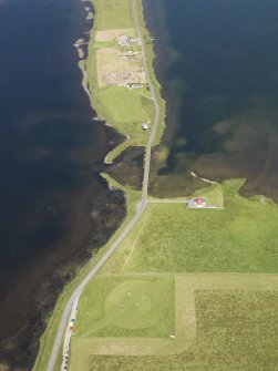 Oblique aerial view of the Stones of Stenness with the excavations at the Ness of Brodgar beyond, taken from the SE.