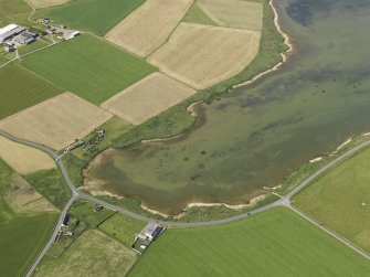 Oblique aerial view of the E end of the Loch of Skaill with West Aith farmstead adjacent, taken from the ENE.
