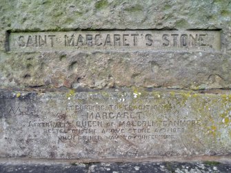 Detail of inscriptions on the S face of the stone and on its plinth.