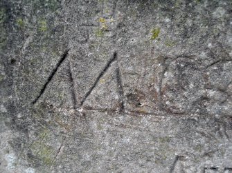 Example of graffiti on the S face of the plinth.