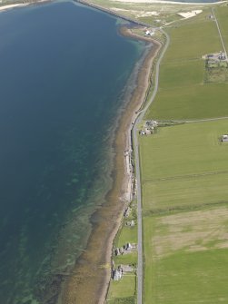 General oblique aerial view looking along the shoreline, taken from the WSW.