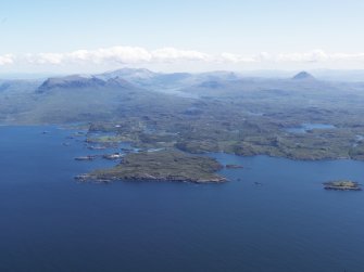 General oblique aerial view of Eddrachllis Bay looking towards Oldany Island with Quinag and Canisp beyond, taken from the NW.