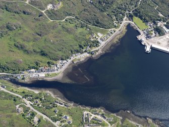 Oblique aerial view centred on the remains of the fish trap in the bay at Lochinver, taken from the NNW.