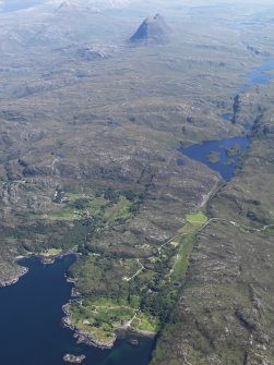 General oblique aerial view of Badnaban looking towards Loch Bad na Muirichinn with Suilven in the distance, taken from the WNW.