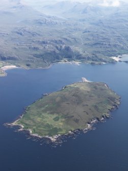 General oblique aerial view of Gruinard Island with Guinard House beyond and An Teallach and Loch na Sealga in the distance, taken from the NW.