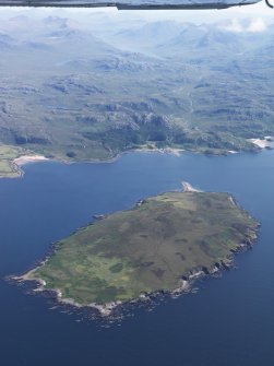 General oblique aerial view of Gruinard Island with Guinard House beyond and An Teallach and Loch na Sealga in the distance, taken from the NW.