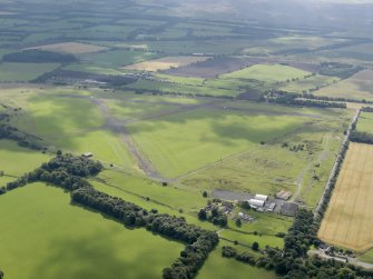 Oblique aerial view of Kirknewton Airfield, looking SE.