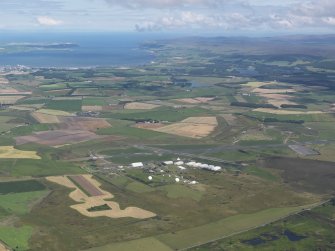 General oblique aerial view with West Freugh Airfield in the foreground and Loch Ryan in the distance, looking NNW.