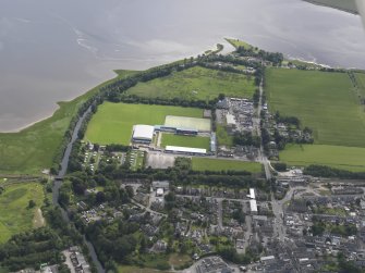 Oblique aerial view of the canal, hospital and stadium in Dingwall, looking E.