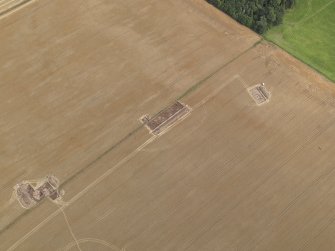 Oblique aerial view of the Glasgow University excavations of the Forteviot complex of sites, looking to the E.