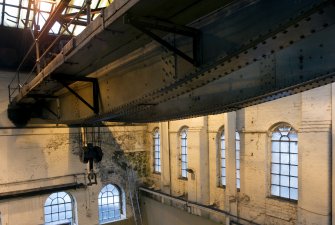 Interior. Main Range (Building 2) west end, 40 Ton crane (Crane 2) with 'fish belly'  shaped lower chord with operator's cabin to right and cross traveller on left.