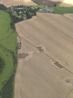 General oblique aerial view of the 2010 excavations at Forteviot with the village beyond, taken from the S.