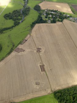 General oblique aerial view of the 2010 excavations at Forteviot with the village beyond, taken from the SSE.