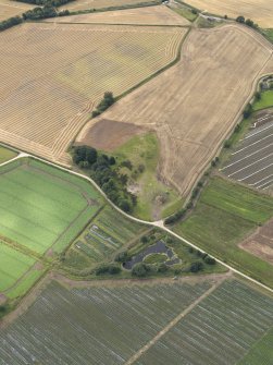 Oblique aerial view of Castle of Rattray quarry, taken from the NNE.