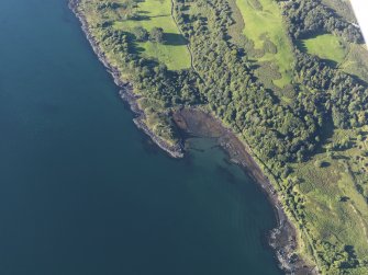 Oblique aerial view of the fort, tower house and fish trap at Caisteal nan Con, looking NE.