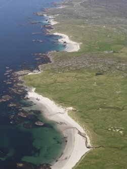 General oblique aerial view of the NW coast of Coll with Cliad Bay in the foreground and Gallanach in the middle distance, looking to the ENE.