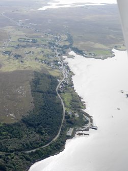 General oblique aerial view of Dunvegan Castle and gardens with Dunvegan village in the distance, looking SSE.