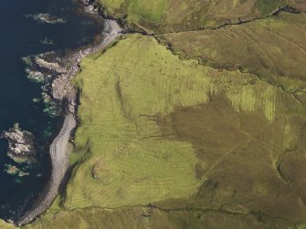 Oblique aerial view of the field system, lazy beds and head dyke at Ramasaig, looking NE.