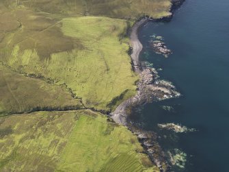 Oblique aerial view of the field system, lazy beds and head dyke at Ramasaig, looking SW.