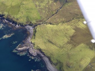 Oblique aerial view of the field system, lazy beds and head dyke at Ramasaig, looking ENE.