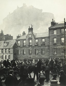 View of horses outside Beehive Hotel, and also showing parts of The Black Bull and 26 Grassmarket, Edinburgh with the Castle in the background. 
Titled: 'The one o'clock gun. Castle from Grassmarket. All Hallow Fair. November 1905'
PHOTOGRAPH ALBUM No.30: OLD EDINBURGH ALBUM