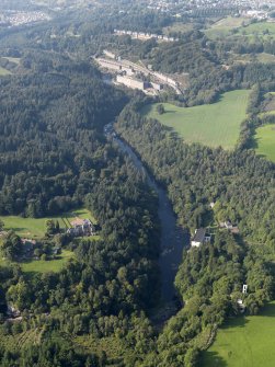 General oblique aerial view centred on Corehouse country house and Bonnington power station with New Lanark village beyond, taken from the S.