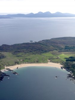 General oblique aerial view of Kiloran Bay looking towards the Paps of Jura, taken from the NNW.