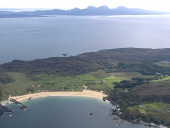 General oblique aerial view of Kiloran Bay looking towards the Paps of Jura, taken from the NW.