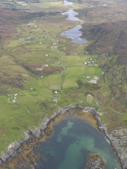 General oblique aerial view of Lower Kilchattan and Upper Kilchattan looking towards Loch Fada with the harbour in the foreground, taken from the SW.