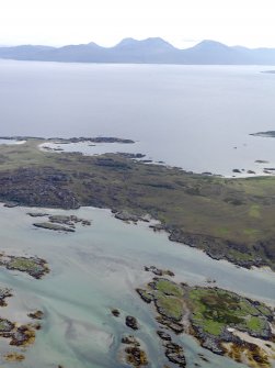 General oblique aerial view of the NE end of Oronsay looking towards the Paps of Jura, taken from the NW.