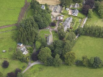 General oblique aerial view of the village centred on the church taken from the W.